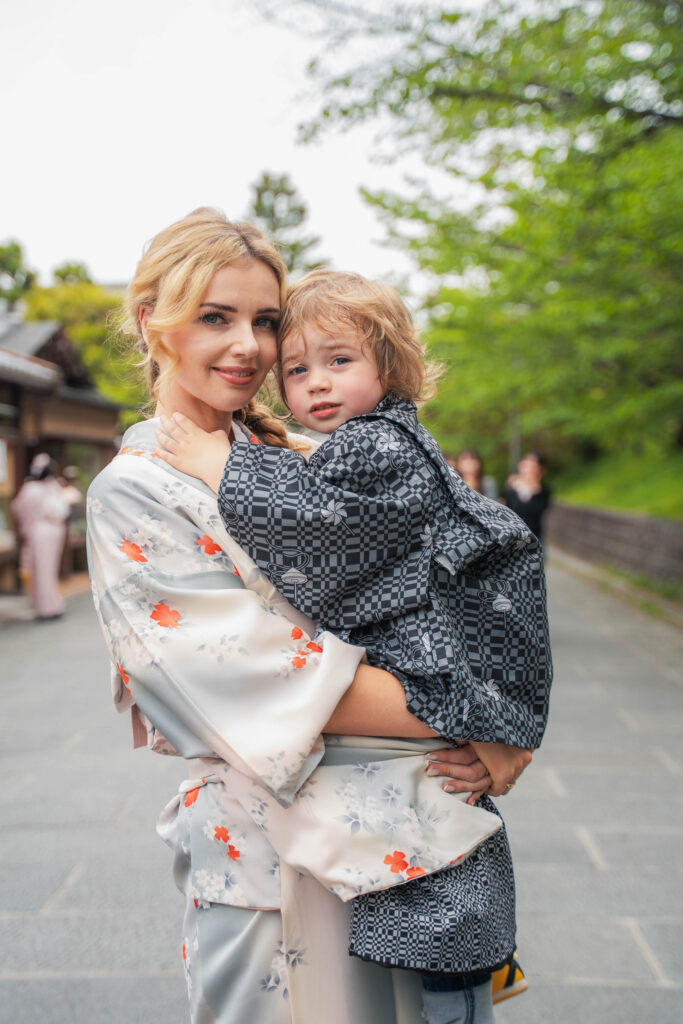 mother in kimono holding her daughter in Kyoto
