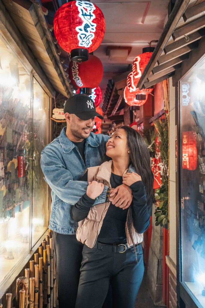 couple posing and looking at each other in Osaka at night